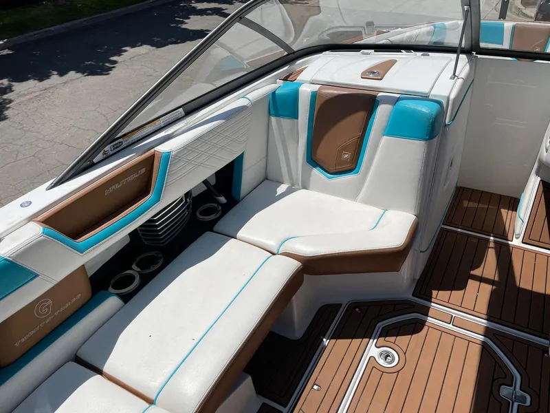 Slide: The Image of 2017 Nautique Super Air G23 interior with white, brown, and teal seating. - 10