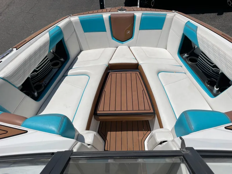 Slide: The Image of 2017 Nautique Super Air G23 boat interior with white and blue seating. - 11