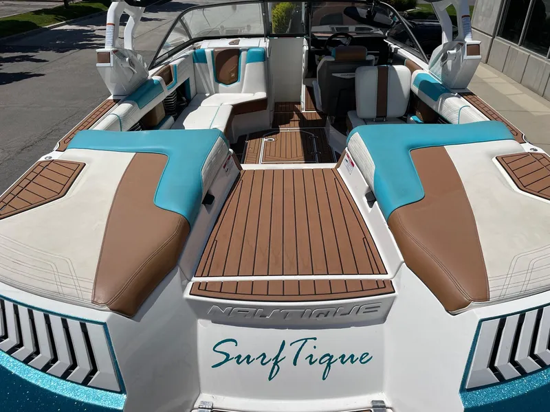 Slide: The Image of 2017 Nautique Super Air G23 boat interior with teal and brown seating. - 4