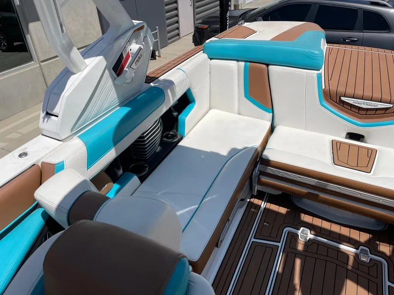 Slide: The Image of 2017 Nautique Super Air G23 interior with blue, white, and brown seating. - 7