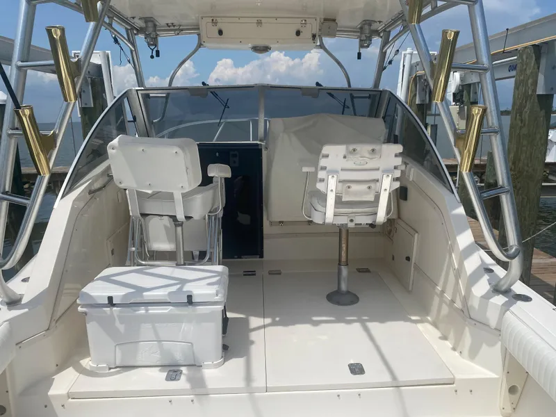 Slide: The Image of 2000 Albemarle 280 Express Fisherman boat interior with seating and fishing equipment. - 17