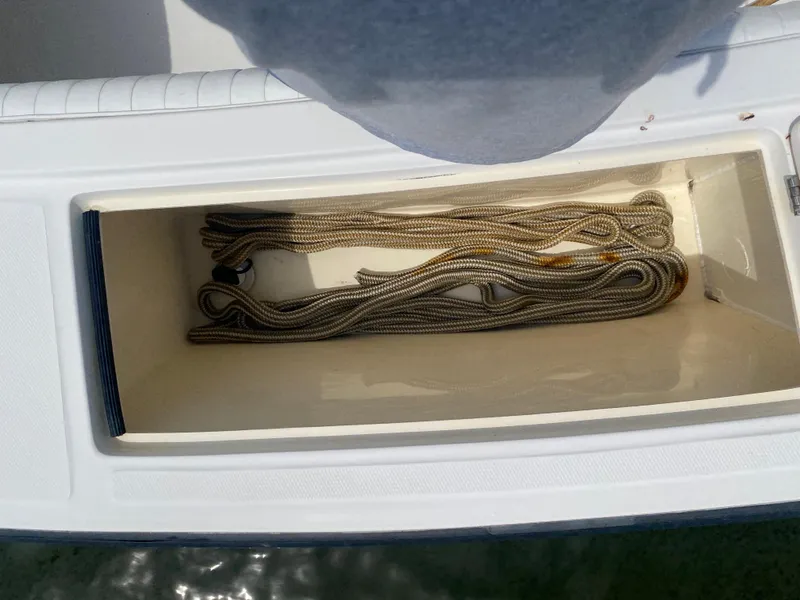 Slide: The Image of Storage compartment with coiled rope on 2000 Albemarle 280 Express Fisherman boat. - 18