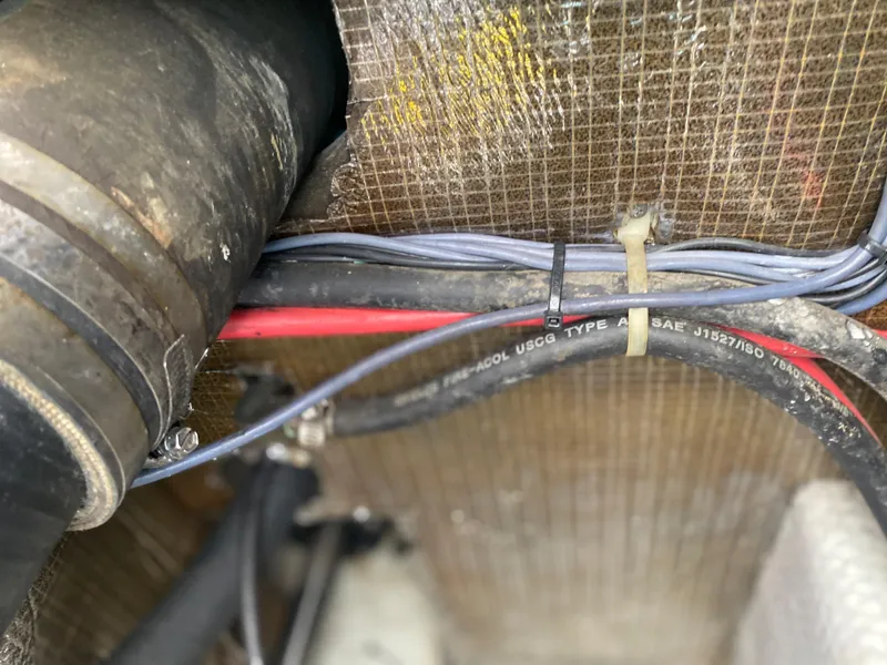 Slide: The Image of Close-up of wiring and hoses in a 2000 Albemarle 280 Express Fisherman boat. - 24