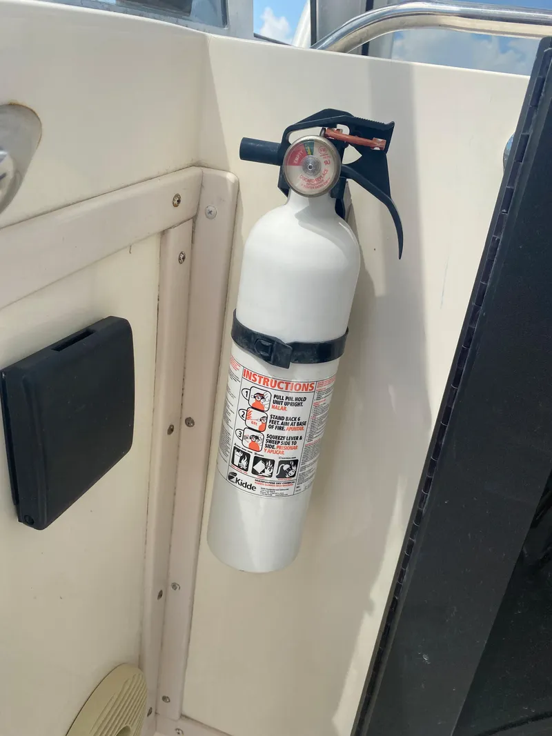 Slide: The Image of Fire extinguisher mounted on 2000 Albemarle 280 Express Fisherman boat interior. - 25