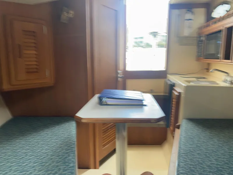 Slide: The Image of Interior of 2000 Albemarle 280 Express Fisherman boat with table and kitchenette. - 28