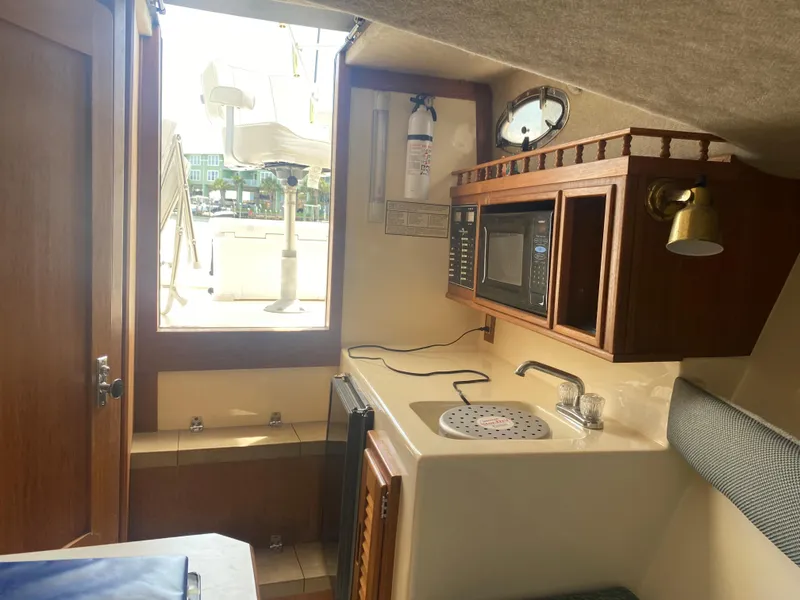 Slide: The Image of Interior of 2000 Albemarle 280 Express Fisherman boat with kitchenette and seating area. - 29