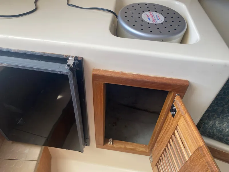 Slide: The Image of 2000 Albemarle 280 Express Fisherman interior with open storage compartments. - 32