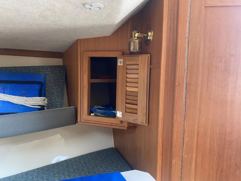 Slide: The Image of Interior cabin of 2000 Albemarle 280 Express Fisherman with wooden storage and seating. - 33