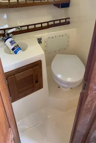 Slide: The Image of 2000 Albemarle 280 Express Fisherman boat bathroom with sink and toilet. - 37