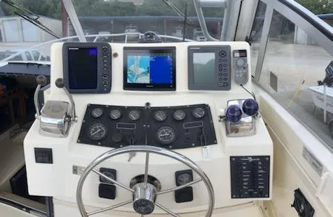 Slide: The Image of 2000 Albemarle 280 Express Fisherman helm with navigation instruments and steering wheel. - 41