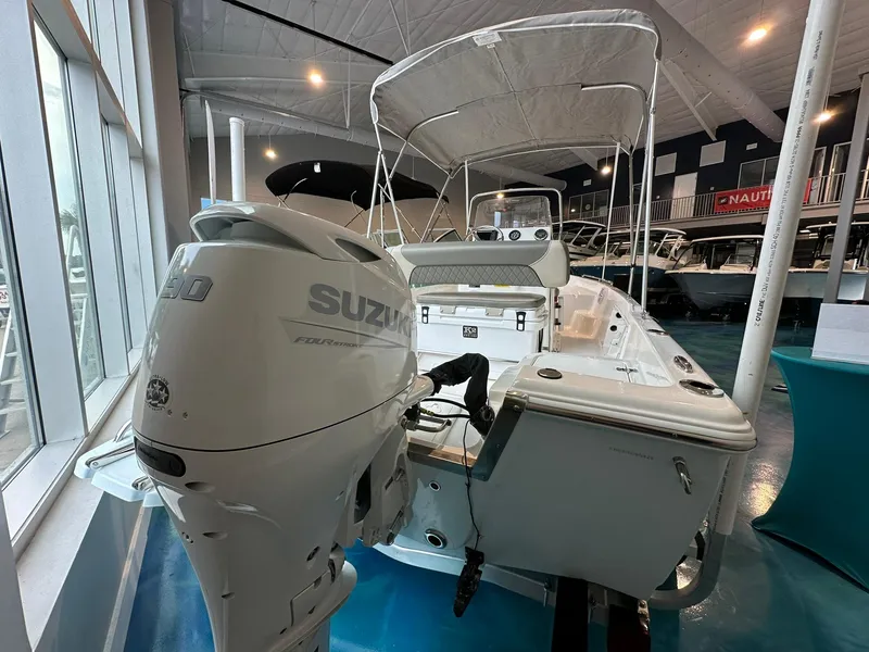 Slide: The Image of 2025 Key West 1720 Center Console boat with Suzuki outboard motor in showroom. - 2