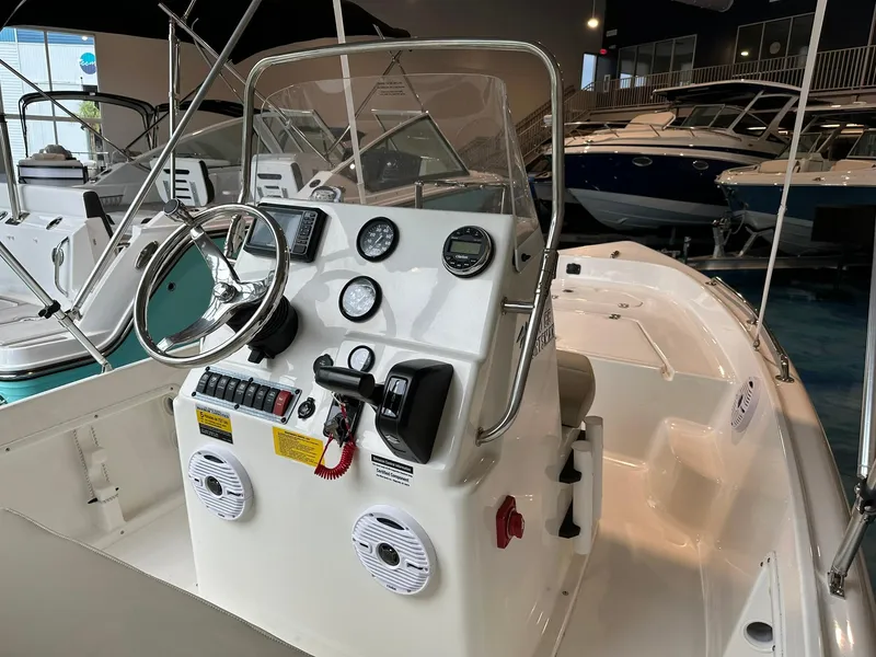 Slide: The Image of 2025 Key West 1720 Center Console boat interior with steering wheel and controls. - 6