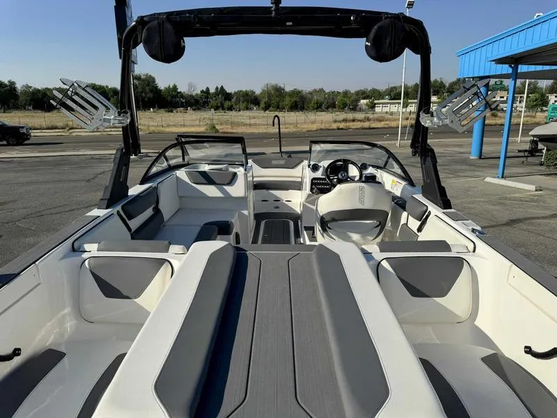 Slide: The Image of 2021 Heyday WT-2 boat interior with seating and steering wheel, parked outdoors. - 21