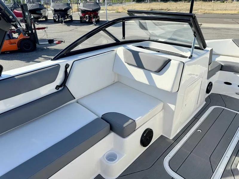 Slide: The Image of 2021 Heyday WT-2 boat interior with gray and white seating, cup holder, and speaker. - 22