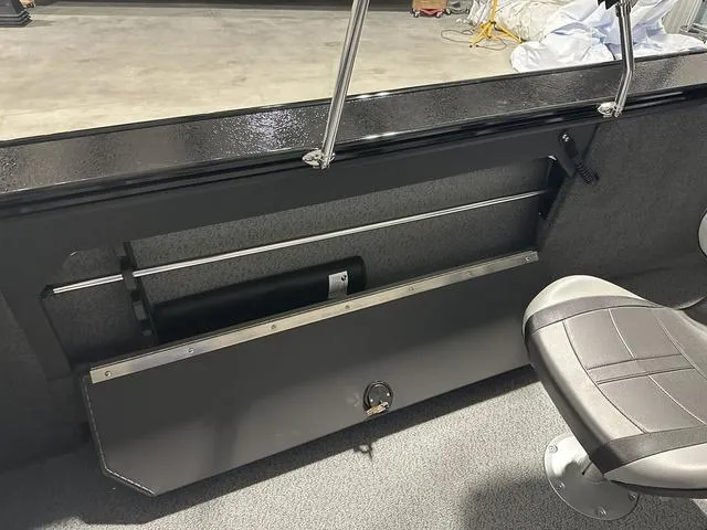 Slide: The Image of 2025 Lund 2075 Fisherman Sport interior with storage compartment and seat. - 10