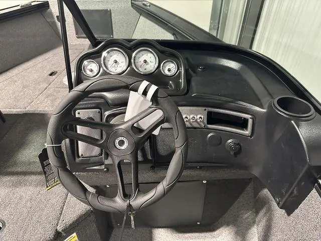 Slide: The Image of Dashboard of 2025 Lund 2075 Fisherman Sport boat with steering wheel and gauges. - 14