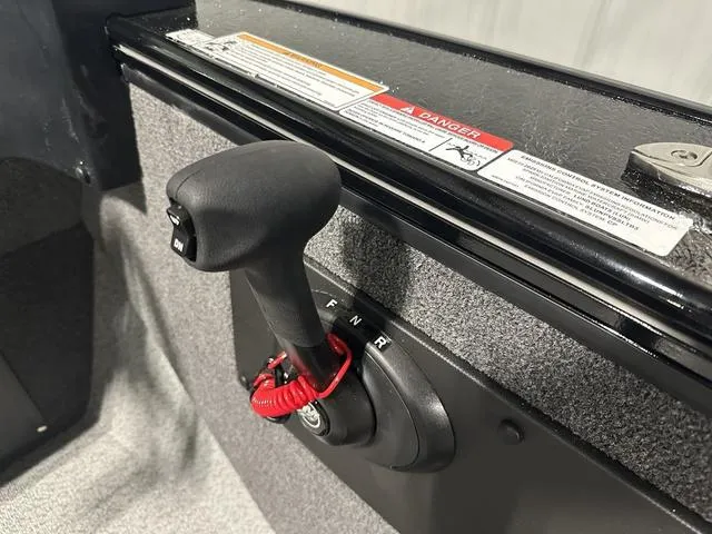 Slide: The Image of 2025 Lund 2075 Fisherman Sport boat throttle control with safety warnings. - 17