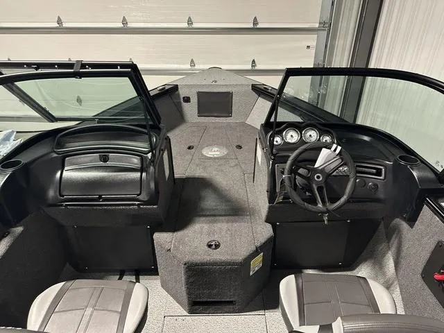 Slide: The Image of 2025 Lund 2075 Fisherman Sport boat interior with dual consoles and seating. - 19