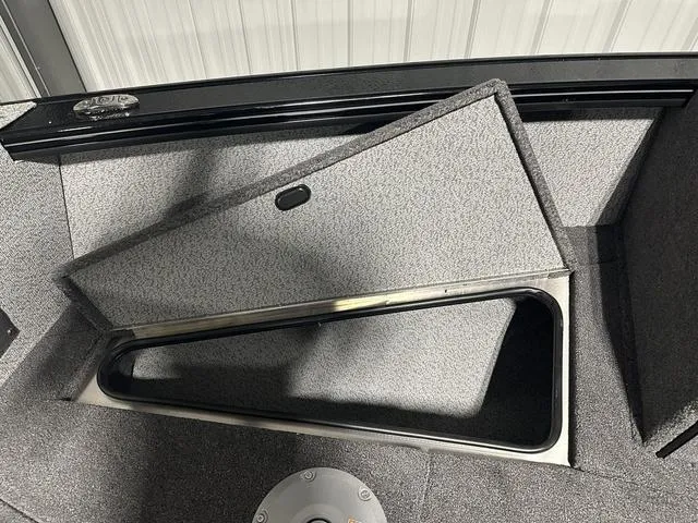 Slide: The Image of 2025 Lund 2075 Fisherman Sport boat storage compartment with open lid. - 23