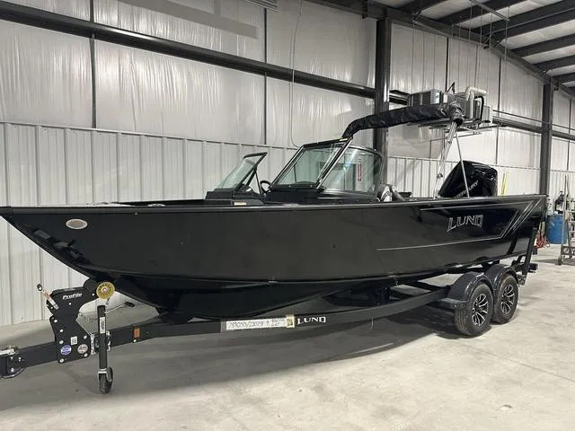 Slide: The Image of 2025 Lund 2075 Fisherman Sport boat in a warehouse setting. - 3