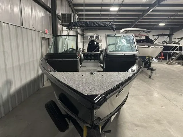 Slide: The Image of 2025 Lund 2075 Fisherman Sport boat in indoor showroom, front view. - 4