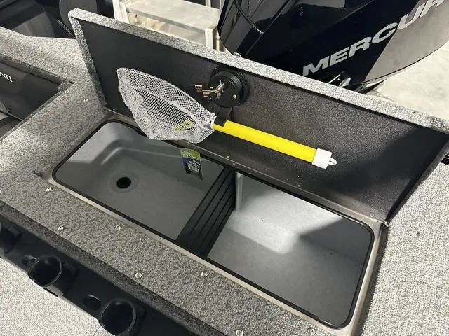 Slide: The Image of Lund 2075 Fisherman Sport 2025 boat with storage compartment and fishing net. - 7