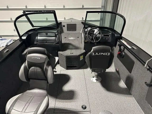 Slide: The Image of 2025 Lund 2075 Fisherman Sport boat interior with dual seats and steering console. - 9