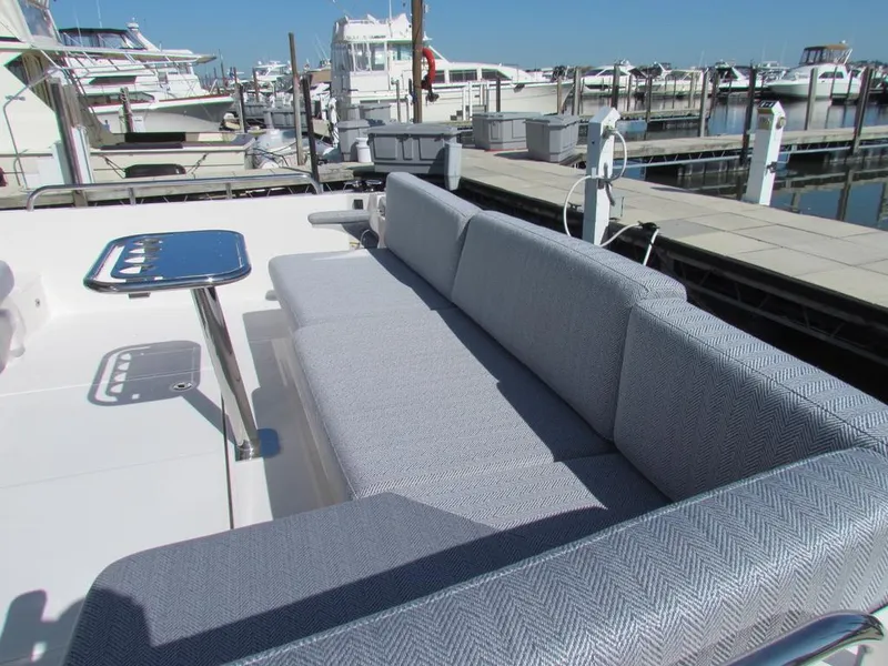 Slide: The Image of 2025 Sabre 43 Salon Express yacht with sleek seating and marina view. - 10