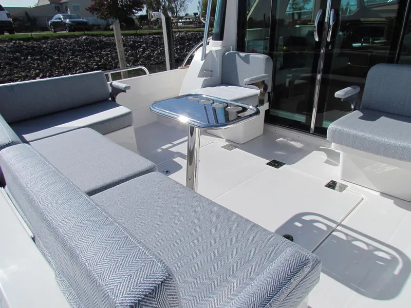 Slide: The Image of 2025 Sabre 43 Salon Express yacht interior with sleek seating and modern table design. - 13