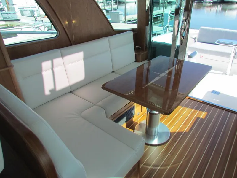 Slide: The Image of Luxurious interior of 2025 Sabre 43 Salon Express yacht with white seating and wooden table. - 16