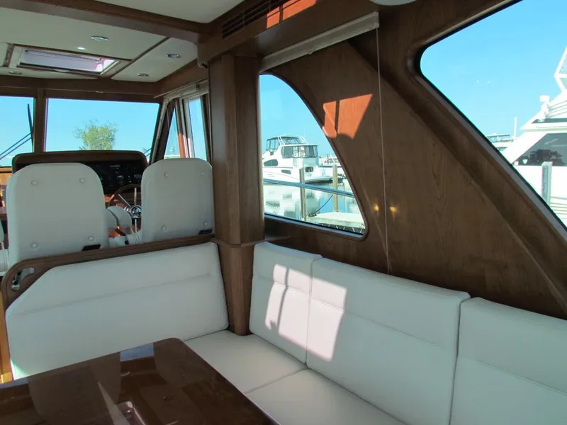 Slide: The Image of Interior of 2025 Sabre 43 Salon Express yacht with white seating and wooden accents. - 18