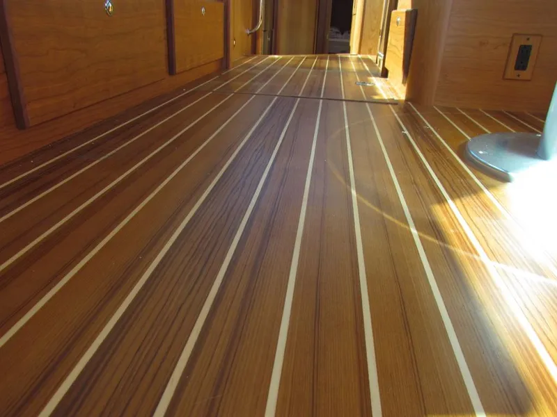 Slide: The Image of Polished wooden floor of 2025 Sabre 43 Salon Express yacht interior. - 19