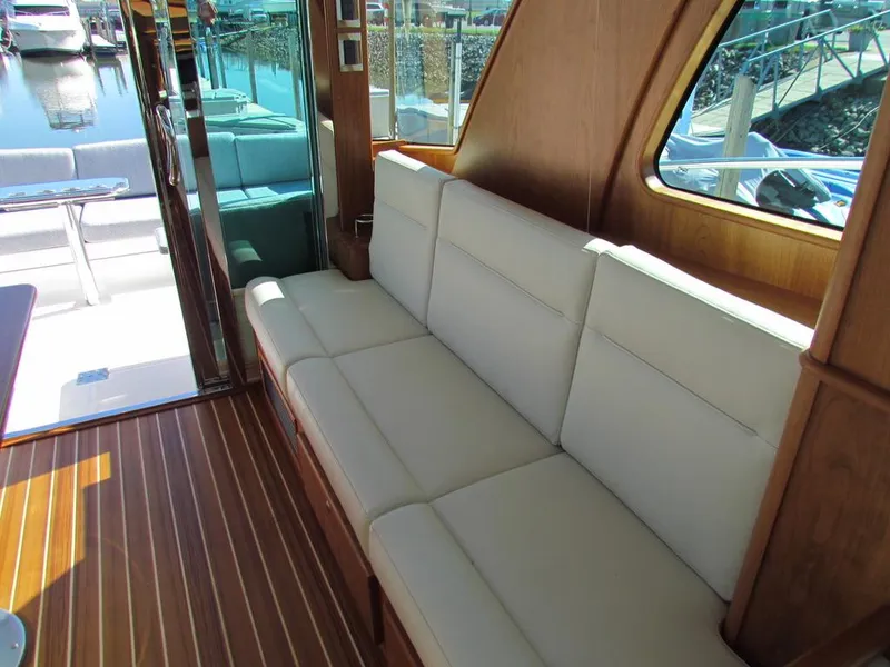 Slide: The Image of Interior of 2025 Sabre 43 Salon Express with elegant seating and wooden flooring. - 20
