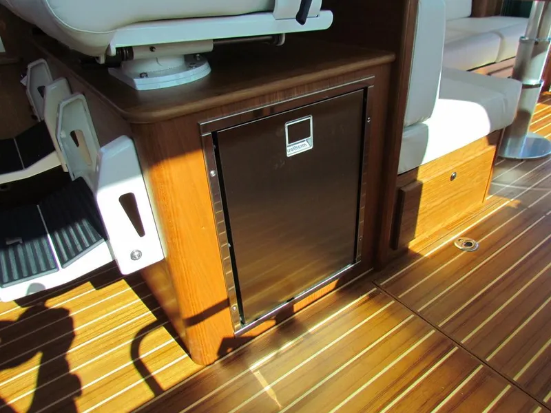 Slide: The Image of Interior of 2025 Sabre 43 Salon Express with wood flooring and seating. - 23