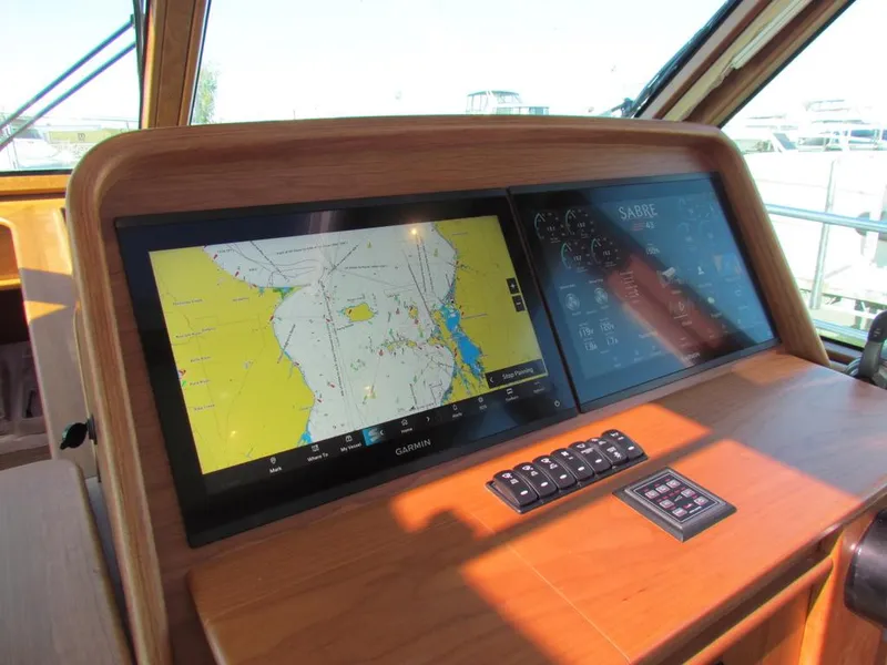 Slide: The Image of 2025 Sabre 43 Salon Express navigation display with dual screens and control panel. - 24