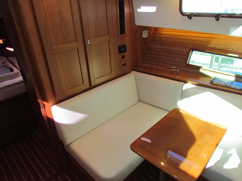 Slide: The Image of Interior of 2025 Sabre 43 Salon Express yacht with wooden table and white seating. - 34