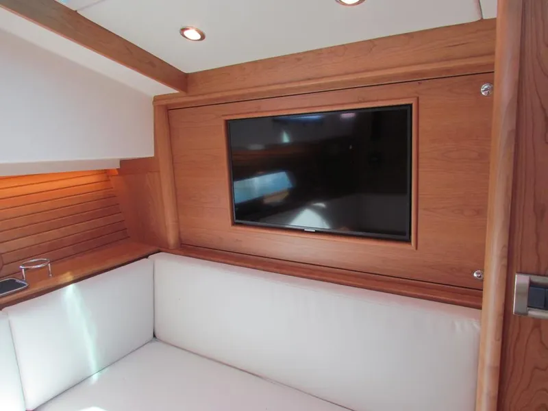 Slide: The Image of Interior of 2025 Sabre 43 Salon Express with wood paneling and mounted TV. - 35
