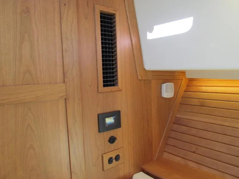 Slide: The Image of Interior of 2025 Sabre 43 Salon Express, featuring wood paneling and modern controls. - 36