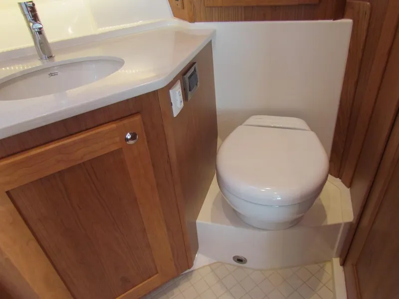 Slide: The Image of 2025 Sabre 43 Salon Express bathroom with wooden cabinetry and modern fixtures. - 38