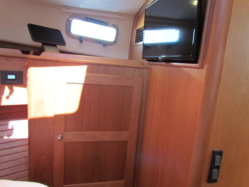 Slide: The Image of Interior of 2025 Sabre 43 Salon Express with wood paneling and mounted TV. - 39