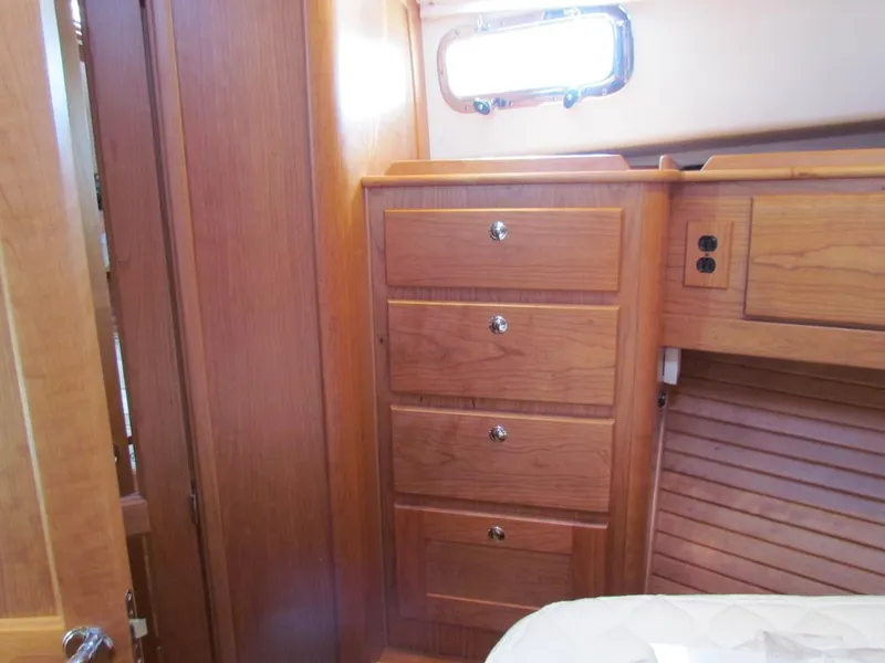 Slide: The Image of Interior of 2025 Sabre 43 Salon Express with wooden cabinetry and drawers. - 40
