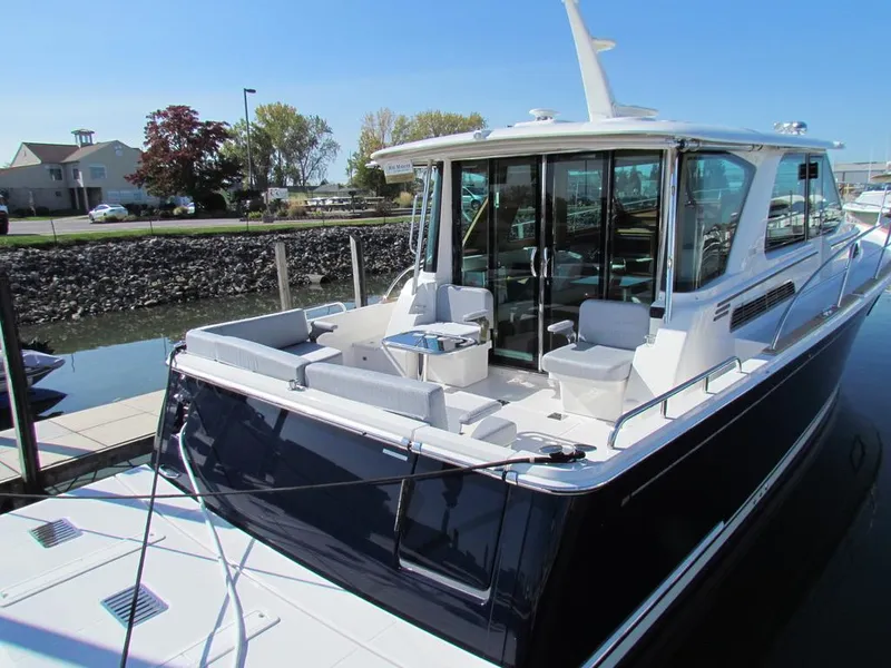 Slide: The Image of 2025 Sabre 43 Salon Express yacht docked, featuring sleek design and spacious deck. - 43