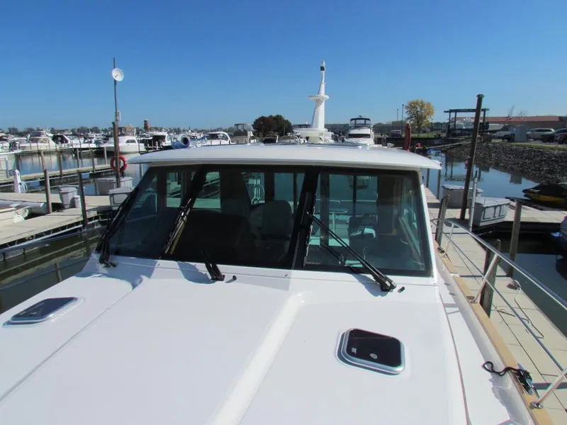 Slide: The Image of 2025 Sabre 43 Salon Express yacht docked at marina, clear sky background. - 45