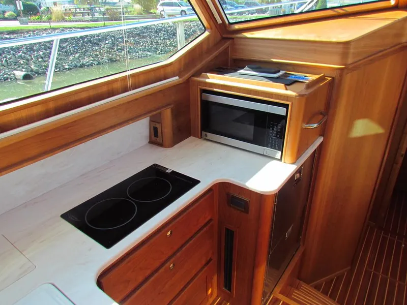 Slide: The Image of 2025 Sabre 43 Salon Express yacht kitchen with stove and microwave. - 6