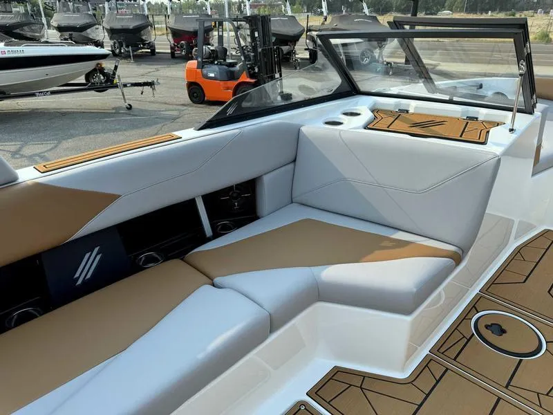 Slide: The Image of 2023 ATX Surf Boats 20 Type-S interior with tan and white seating. - 10