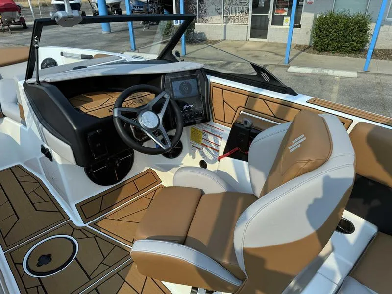 Slide: The Image of 2023 ATX Surf Boats 20 Type-S interior with tan and white seating, modern dashboard, and steering wheel. - 11