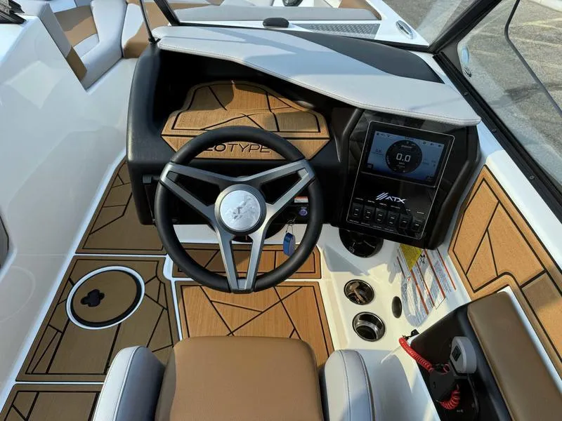 Slide: The Image of 2023 ATX Surf Boats 20 Type-S dashboard with steering wheel and digital display. - 12