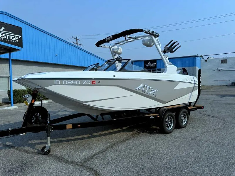 Slide: The Image of 2023 ATX Surf Boats 20 Type-S on trailer, parked outside a blue building. - 3