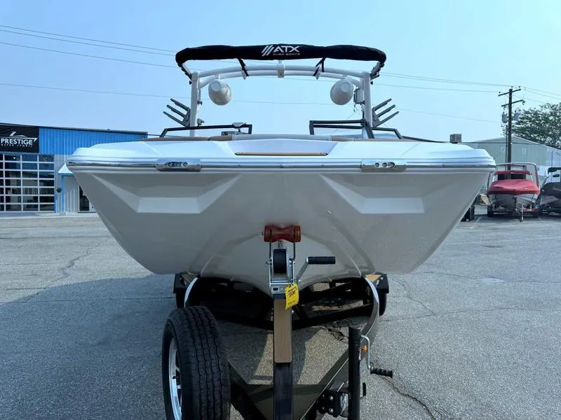 Slide: The Image of 2023 ATX Surf Boats 20 Type-S on trailer, front view, in a parking lot. - 4