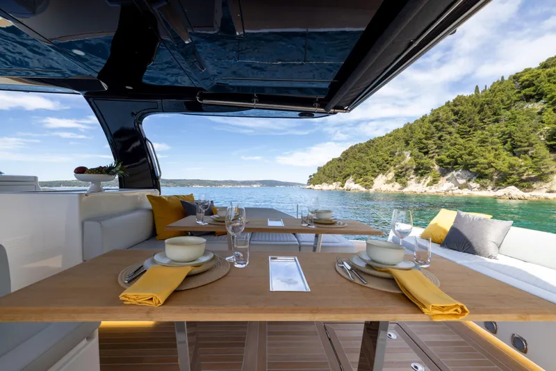 Slide: The Image of Luxurious dining setup on 2025 Solaris Power 60 Open yacht, with scenic ocean view. - 12